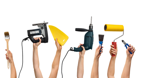 set of the tools for home repair in human hands, on white backgroundの写真素材