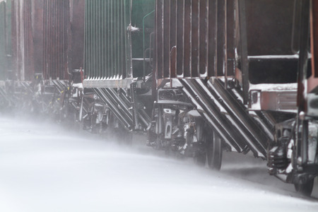 freight train go by rail through the snowdriftの写真素材