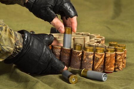 hands of shooter with a bandolier and ammunition, closeupの写真素材