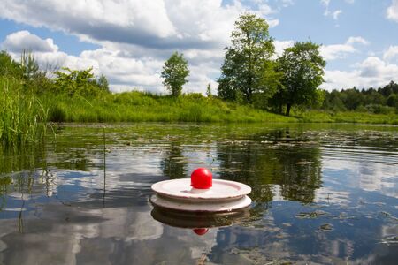 fishing trap (circle) signals bite of predatory fish on the surface of the lakeの写真素材
