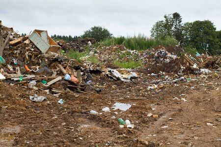 large open-air garbage dump for household waste in the forestの写真素材