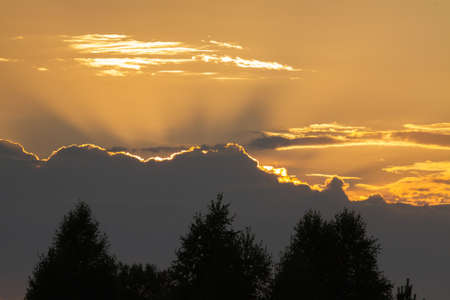 a thundercloud obscured the sun in the evening skyの写真素材