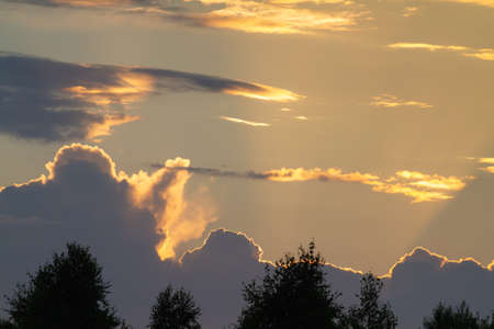 a dark thundercloud is moving across the evening skyの写真素材