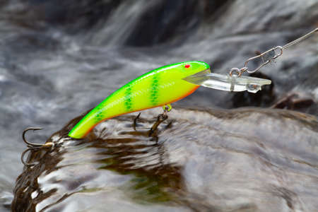 bright green wobbler lying on a pitfalls in the middle of a rapid