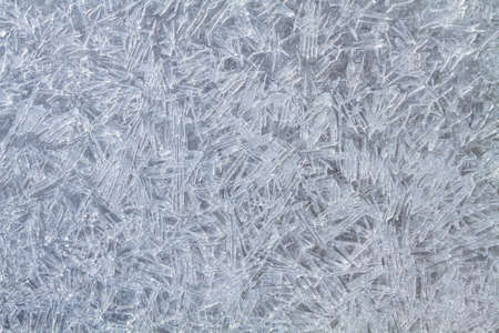 The ice needles froze together, forming a patterned surface. Abstract winter background for New Year and Christmas.の写真素材