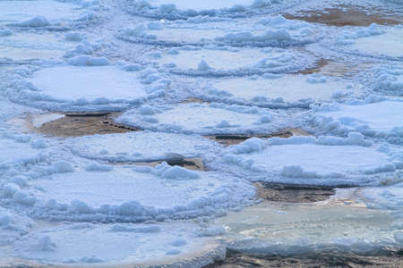a few washouts among the frozen round ice floes on the river on a frosty morning