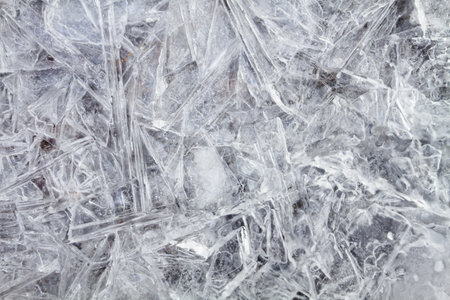 A patterned ice surface consisting of many large ice crystals frozen together. Abstract winter background for Christmas and New Year.の写真素材