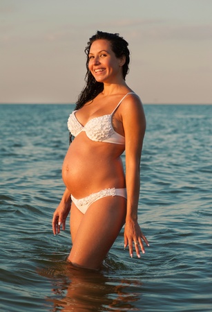 Pregnant woman bathing in the seaの写真素材