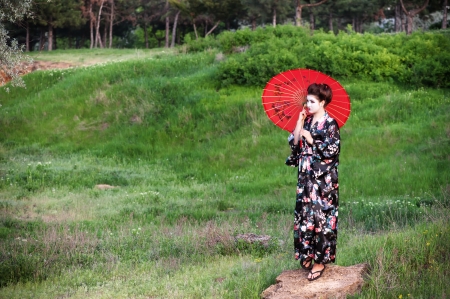 Asian style portrait of walking woman with umbrellaの写真素材