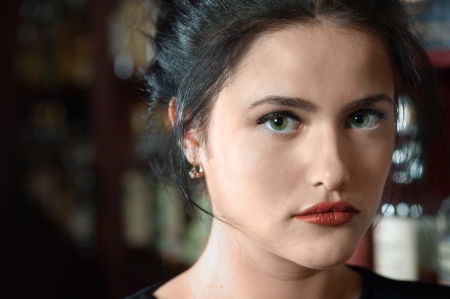 Portrait of young brunette woman against a barの写真素材