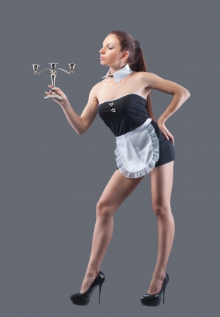 Woman in french maid costume, isolated on greyの写真素材