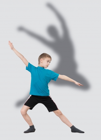 Warming up boy with dancer s silhouette behind himの写真素材