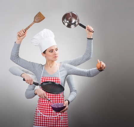 Busy housewife concept with many hands on grey backgroundの写真素材