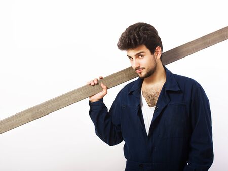 Handsome workman carrying a wooden timber, white backgroundの写真素材