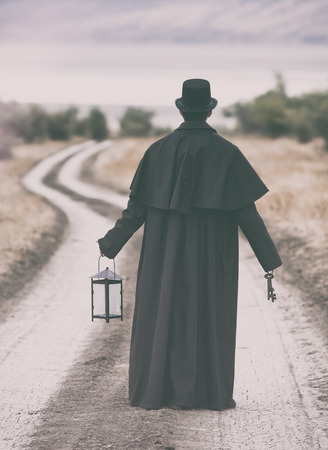 Stylized portrait of a man in garrick coat walking on the rural path