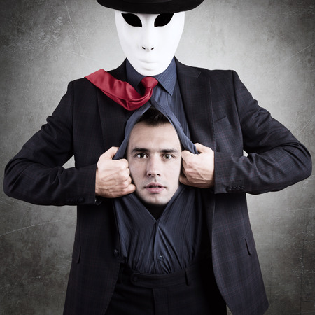 Man in mask showing his true face, conceptの写真素材