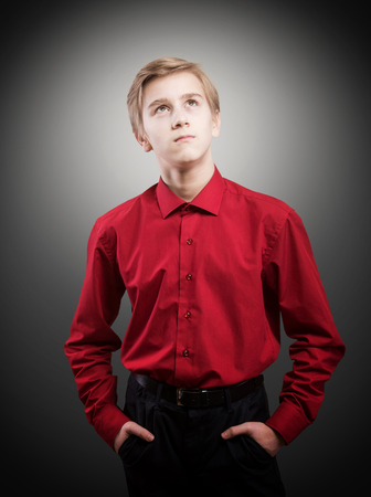 Studio portrait of thinking teenager.の写真素材