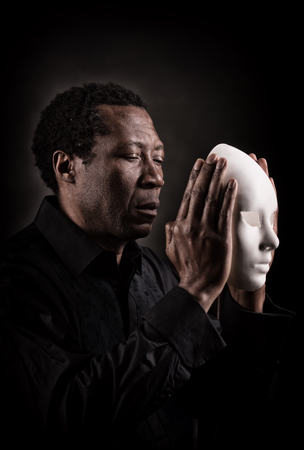 Dramatic art portrait of african black man with white mask.の写真素材