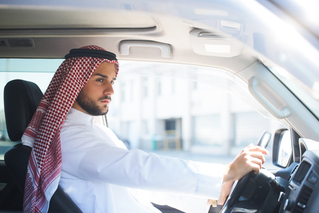 Portrait of a handsome arabian man driving a carの写真素材