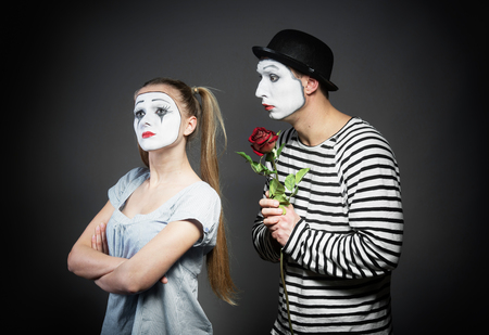 Male mime giving a flower to female mimeの写真素材