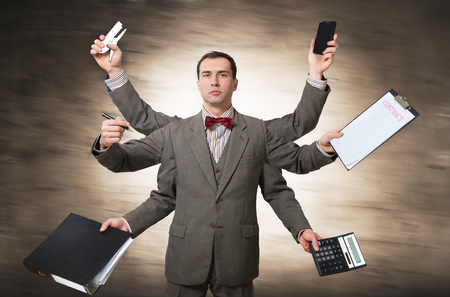 Office worker with many hands, conceptの写真素材
