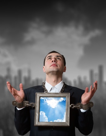 Chained businessman with a boardの写真素材