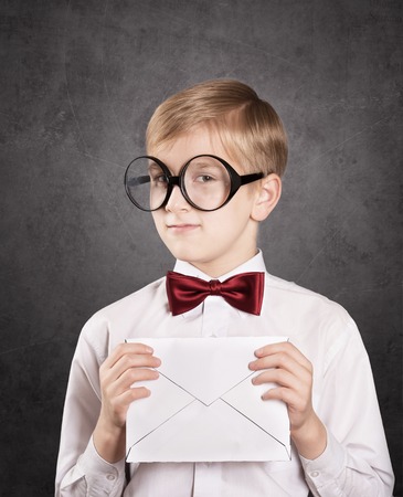 Serious boy with the letter. Retro style portraitの写真素材