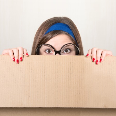 Woman hiding in a moving boxの写真素材