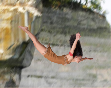 Girl diving off a cliffの写真素材