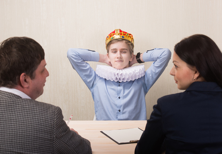 Funny portrait of young man during job interview and members of managemenの写真素材