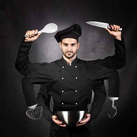 portrait of a chef with many hands on gray background. Kitchen machine concept.の写真素材
