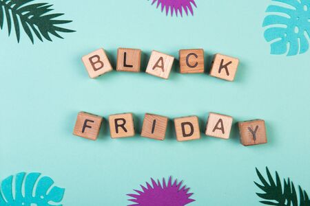 Black friday sale shopping concept alphabet on wooden blocks. Design concept for social media and banners on mint background.の写真素材