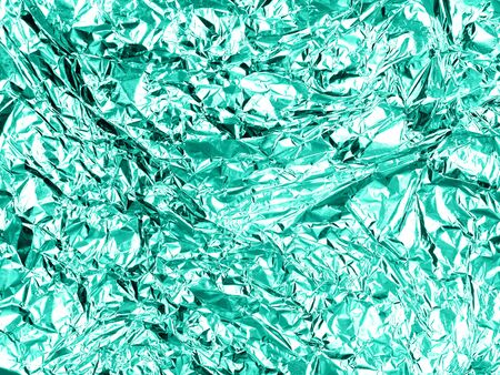 Shiny wrinkled metal foil abstract texture background. Greeting card design concept.の写真素材