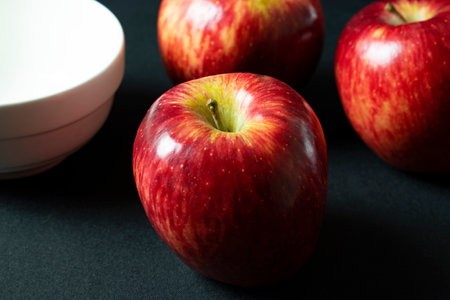 Red apples on a black background. Selective focus. Shallow depth of fieldの写真素材