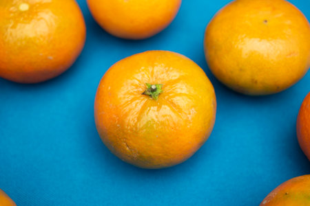 Oranges on a blue background. Top view. Copy space.の写真素材