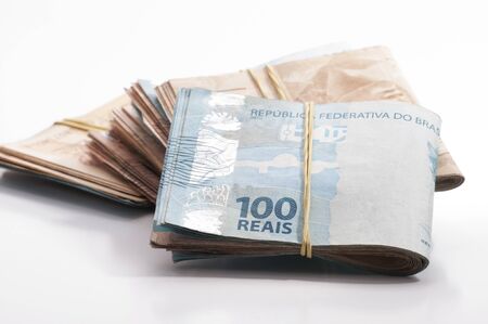 A few bills of brazilian currency (real) on white backgroundの写真素材