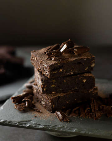 Chocolate Brownie with banana, coconut and almond on gray slate - Fit and delicious dessertの写真素材