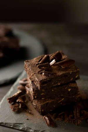 Chocolate Brownie with banana, coconut and almond on gray slate - Fit and delicious dessertの写真素材