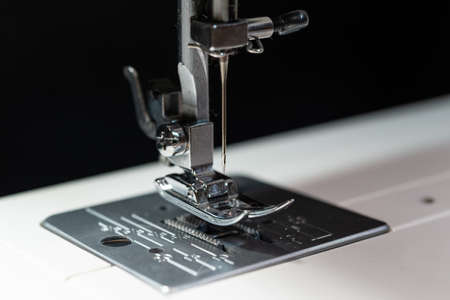 Close up photo of a modern sewing machine with a needleの写真素材