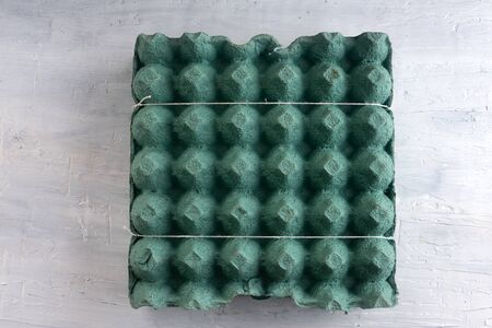 egg carton on a rustic white table.