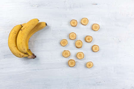 Nanica banana on top of banana leaf on white background. Top View.の写真素材