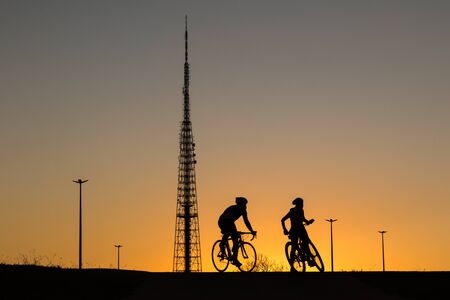 People enjoy the sunset and exercise next to the TV Tower in Brasilia, Brazil.の写真素材