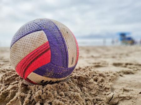 Colorful voley ball resting on the beach sandの写真素材