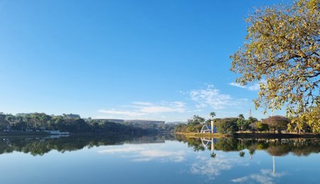 Pampulha Church overlooking the Pampulha Lagoon, with reflection in the water and blue skyの写真素材