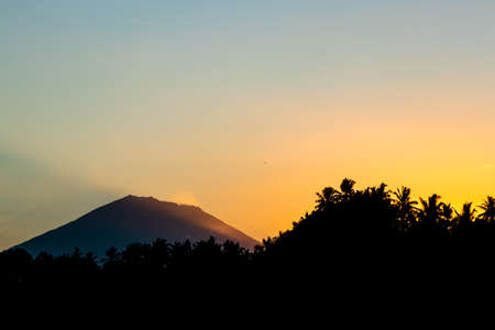 Sunrays hitting a mountain at sunrise.