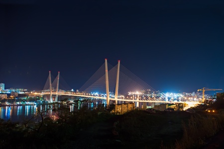 night view of the bridge in the Russian Vladivostok over the Golden Horn bayの写真素材