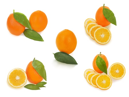 set of fresh ripe orange fruits with cut and green leaves isolated on white backgroundの写真素材