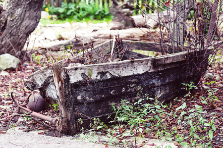 Last place of old broken boat in autumn garden. Vintage style.の写真素材