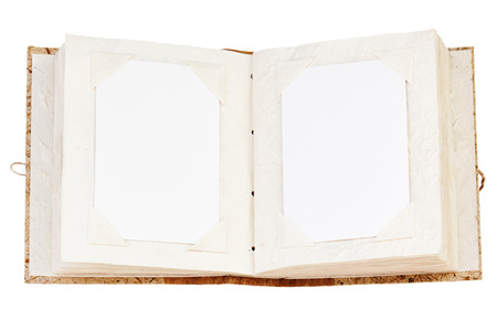 Open old photo album with place for your photos isolated on white background. Closeup.の写真素材