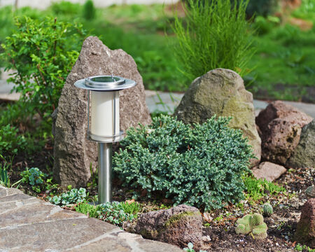 Solar-powered lamp on garden background. Selective focus.の写真素材